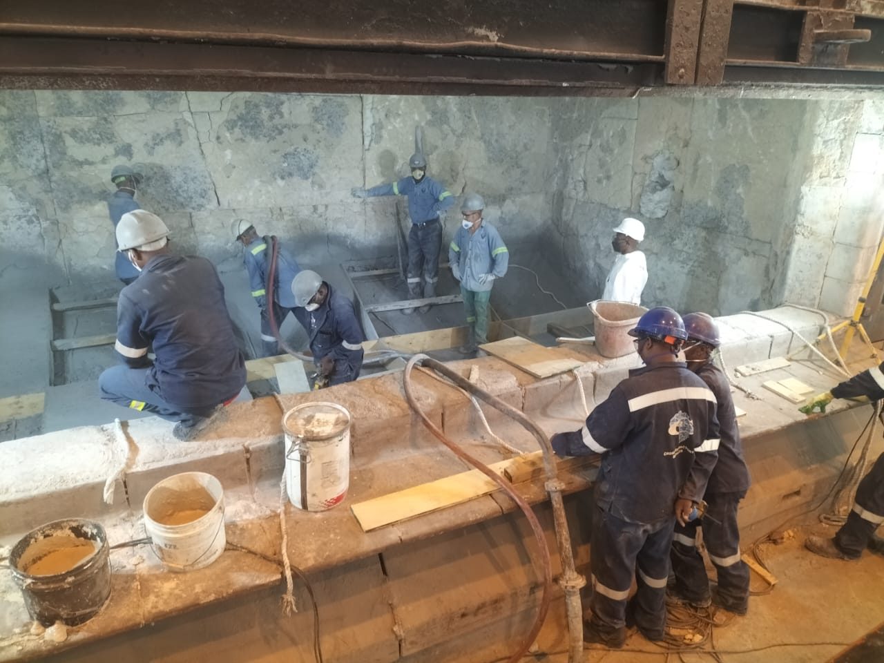 Cross Refractory crew gunning a refractory lining in full protective equipment