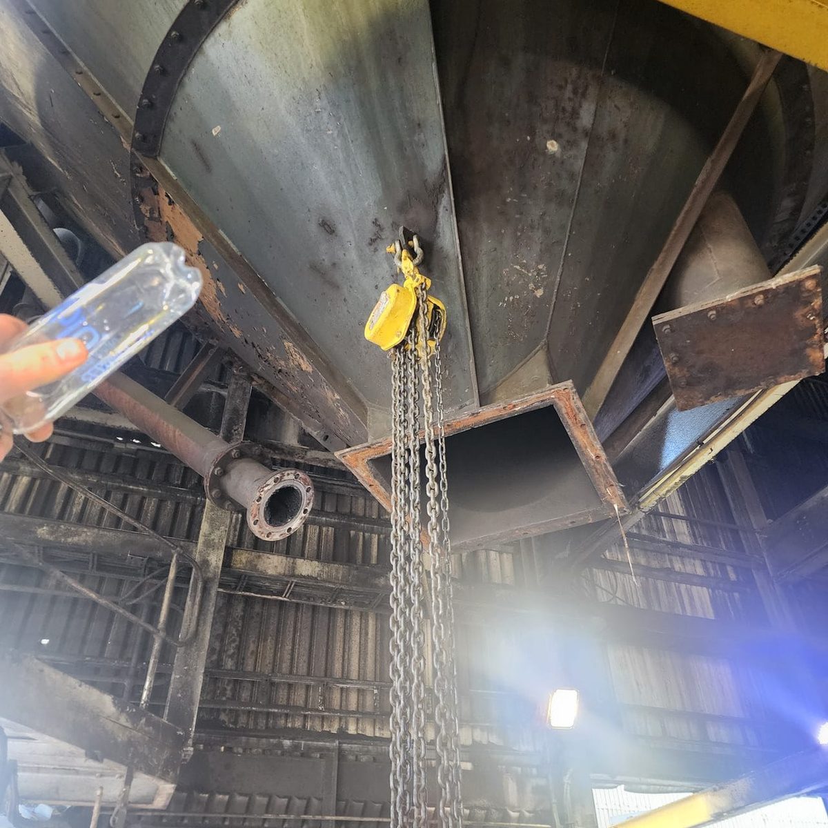 Steel gas producer shell lifted into position for relining